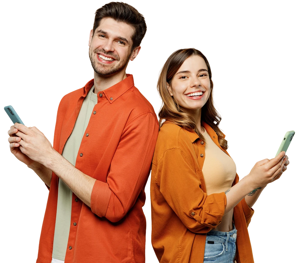 Smiling couple standing back to back, each holding a phone